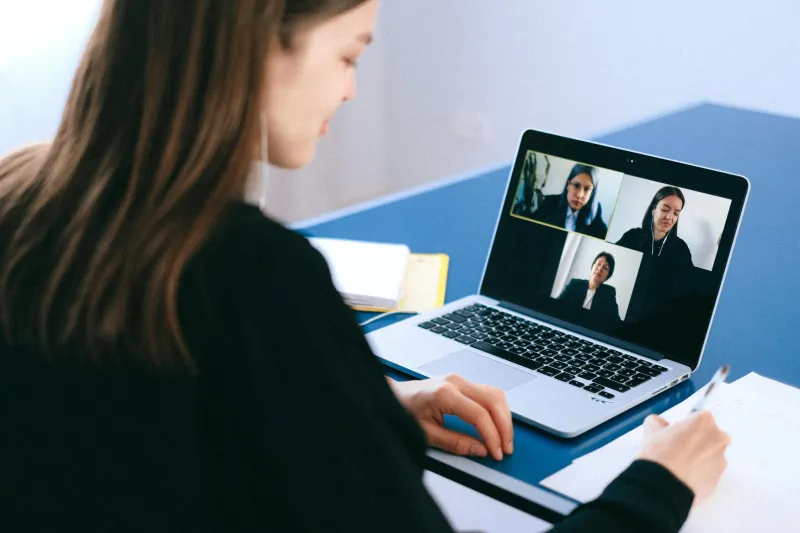 One individual using web meeting software with three others on screen